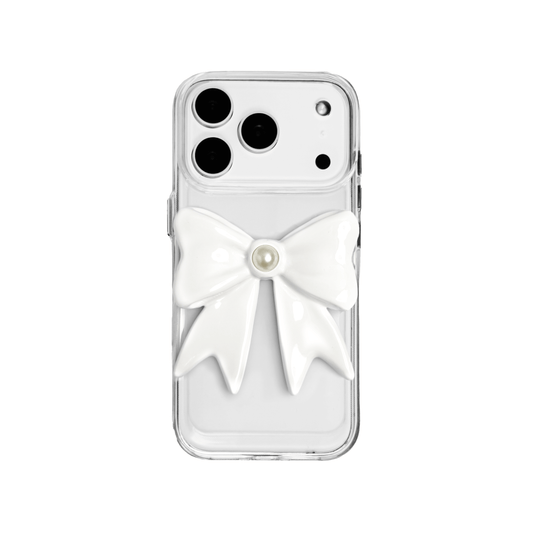 A set of two iPhone cases, both featuring a large, 3D bow charm centered on the back. One case shows a black bow and the other a white bow, with a single white pearl embedded at the center of each bow. The phone cases appear to have a silver or transparent base.
