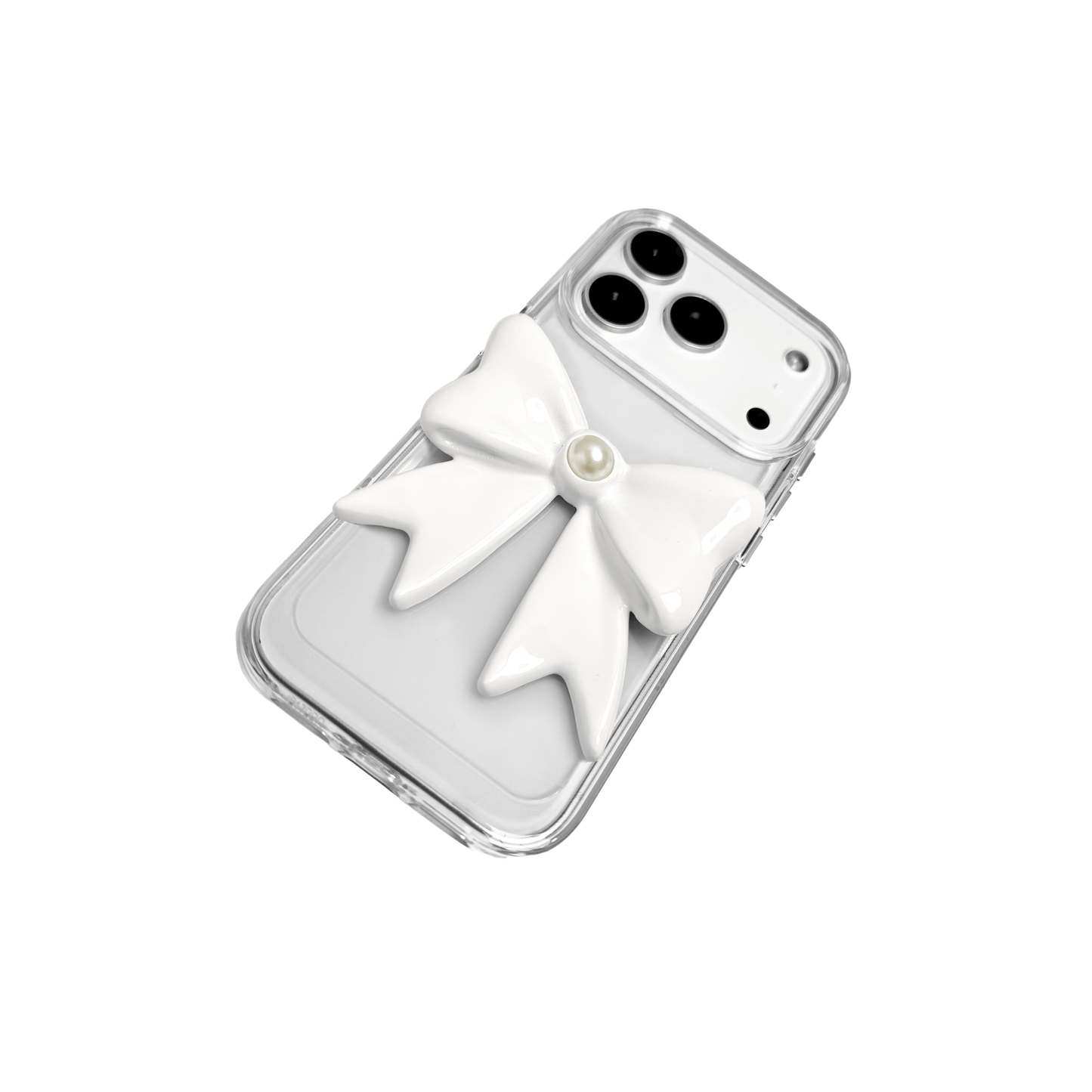 A set of two iPhone cases, both featuring a large, 3D bow charm centered on the back. One case shows a black bow and the other a white bow, with a single white pearl embedded at the center of each bow. The phone cases appear to have a silver or transparent base.