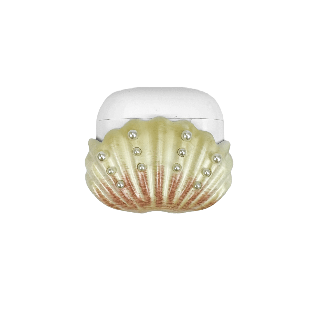 Shell-shaped headphone accessory with flowing ridges and embedded pearl-like orbs, designed to wrap around the device in a soft, ocean-inspired form.