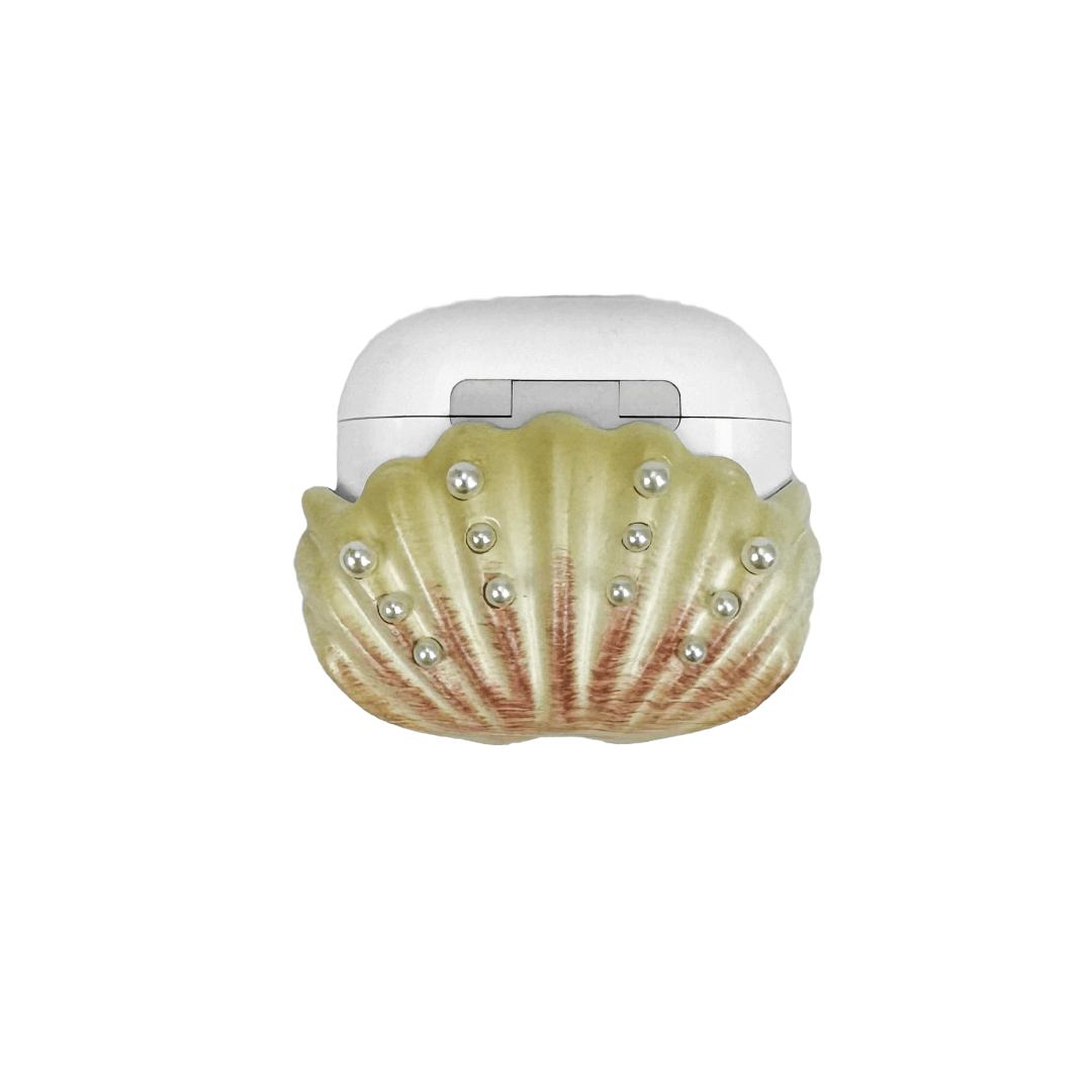 Shell-shaped headphone accessory with flowing ridges and embedded pearl-like orbs, designed to wrap around the device in a soft, ocean-inspired form.