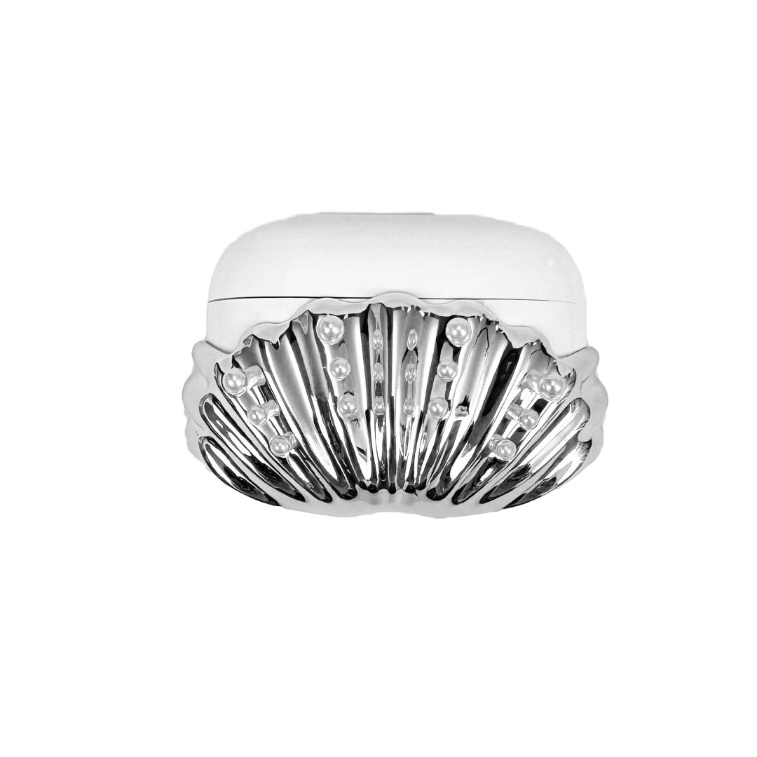 Shell-shaped headphone accessory with flowing ridges and embedded pearl-like orbs, designed to wrap around the device in a soft, ocean-inspired form.