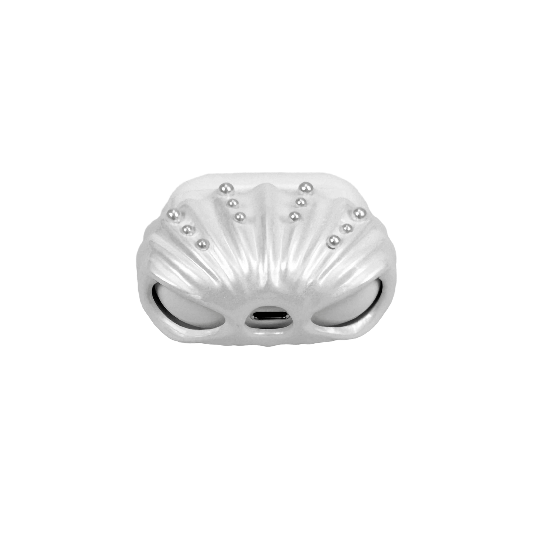 Shell-shaped headphone accessory with flowing ridges and embedded pearl-like orbs, designed to wrap around the device in a soft, ocean-inspired form.