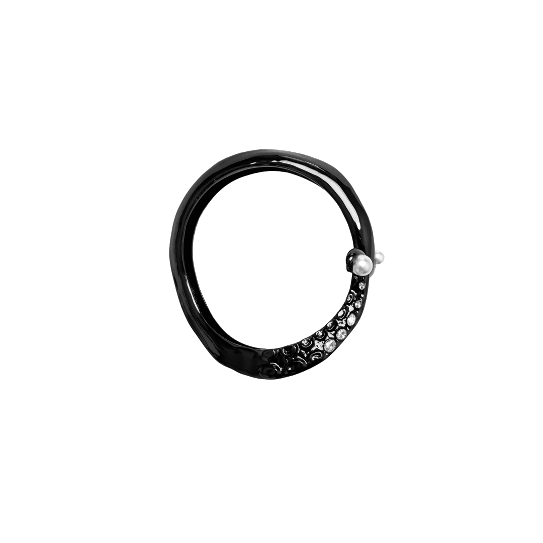 Black and silver octopus-inspired bracelet with pearl detail.