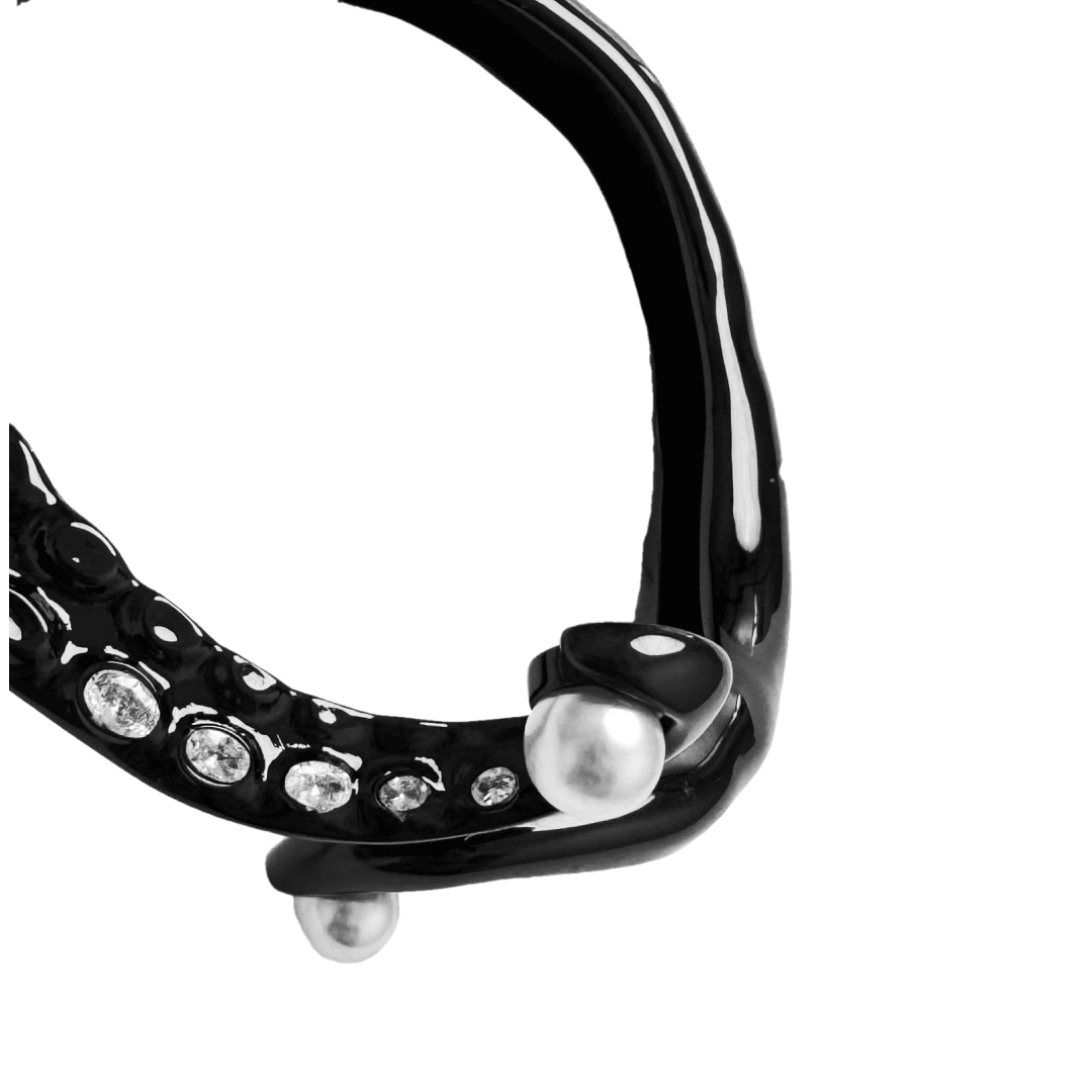 Black and silver octopus-inspired bracelet with pearl detail.