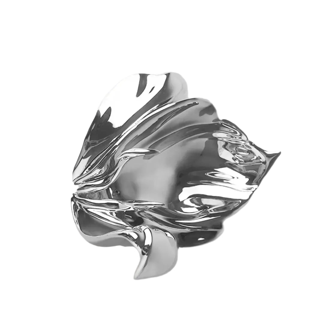Futuristic chrome incense holder with flowing petal silhouette – organic metallic design cradling incense stick in sculptural bloom