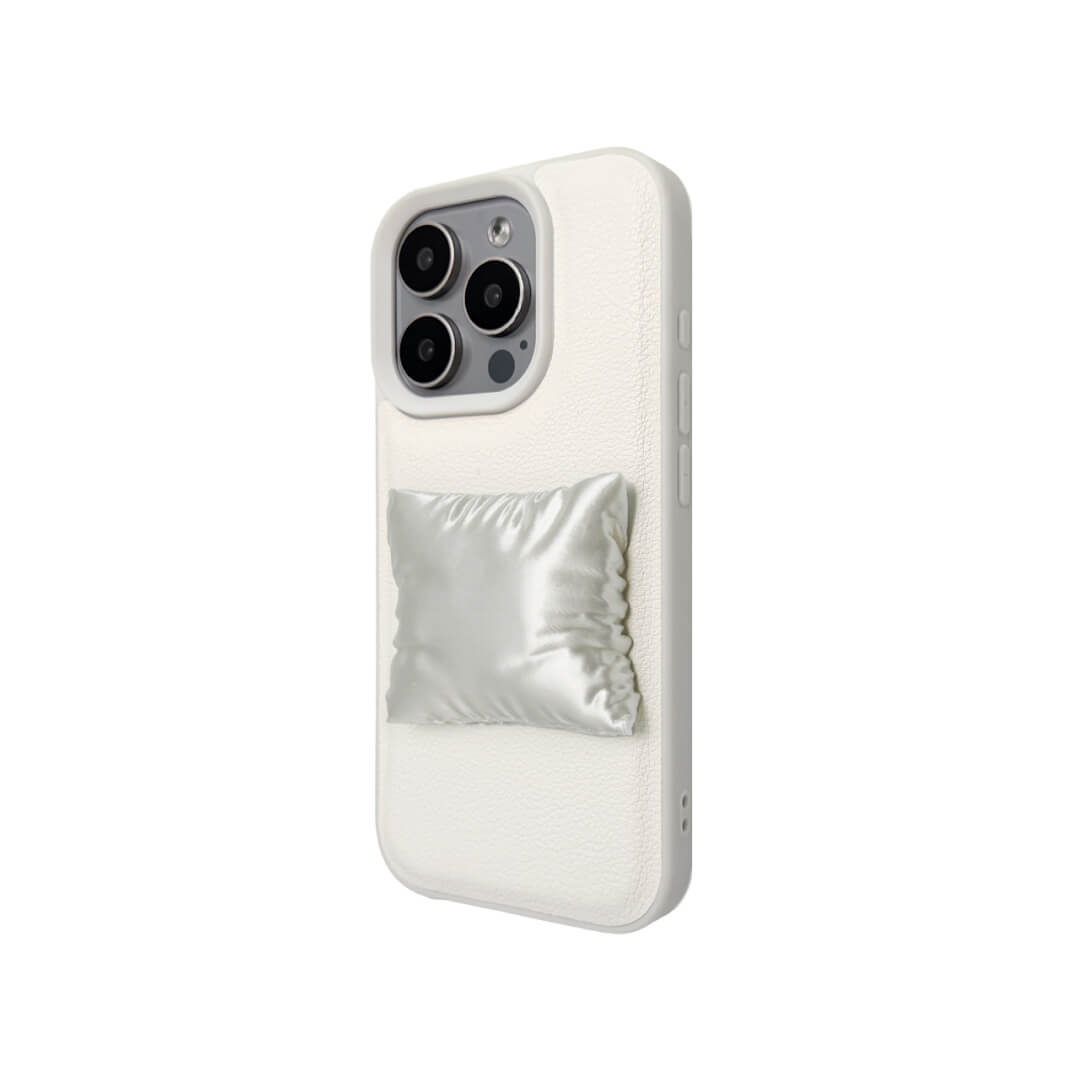 Two Pillow iPhone Cases: one with a transparent case and one with a white lychee leather case. Both feature the 3D sculpted silver/white pillow detail.