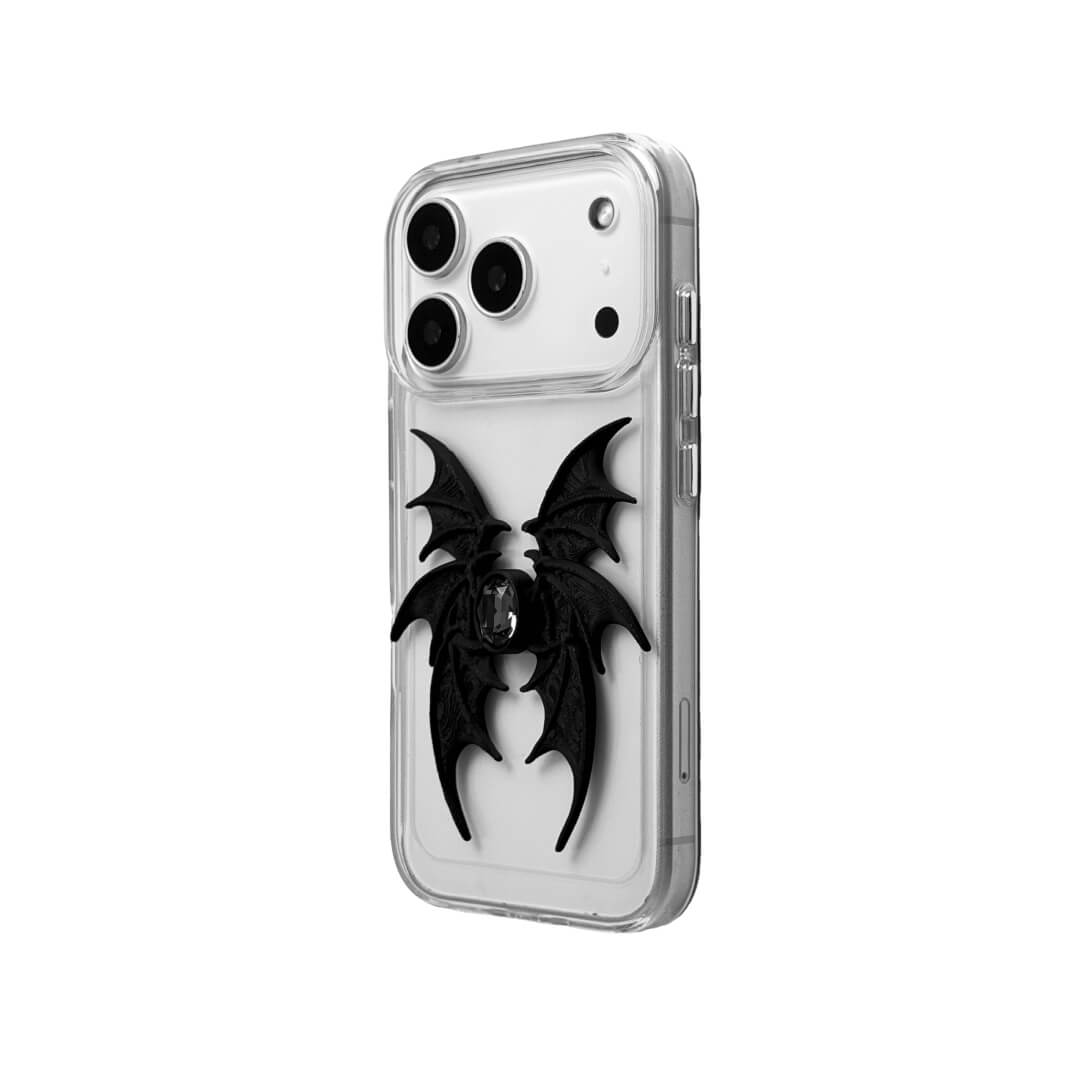A high-concept iPhone case featuring a 3D-printed quad-wing demon design in a natural matte black finish, centered with a sparkling black Swarovski crystal. The design is shown on a Clear Transparent base and a Black Litchi Leather textured base, highlighting the intricate, layered skeletal wing structure and the dark gemstone detail.
