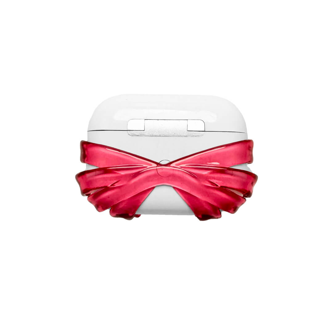Ribbon Magic Bear AirPods Cover featuring a beige gummy bear with closed eyes, holding a pink crystal heart, framed by layered translucent pink ribbons.