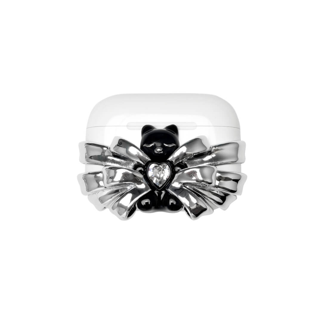 Silver ribbon AirPods cover with a black bear charm and heart centerpiece