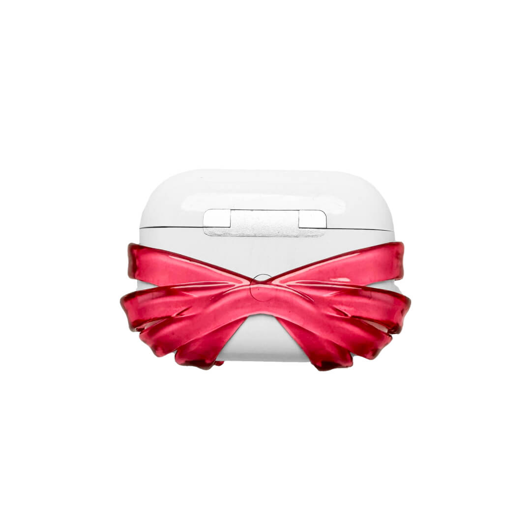 Ribbon Magic Bear AirPods Cover featuring a beige gummy bear with closed eyes, holding a pink crystal heart, framed by layered translucent pink ribbons.