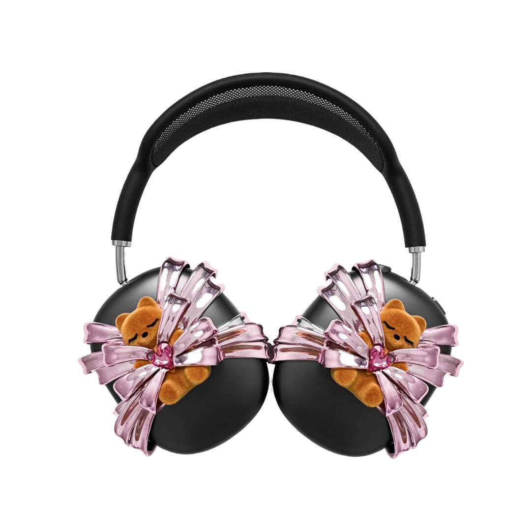 Ribbon Gummy Bear AirPods Max cover in Pink Edition, featuring a beige bear holding a pink crystal heart, surrounded by layered metallic pink ribbons.