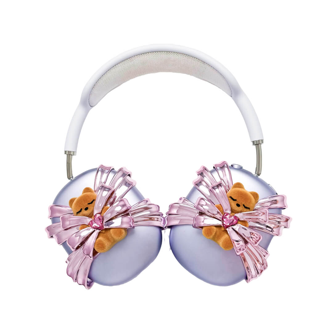 Ribbon Gummy Bear AirPods Max cover in Pink Edition, featuring a beige bear holding a pink crystal heart, surrounded by layered metallic pink ribbons.