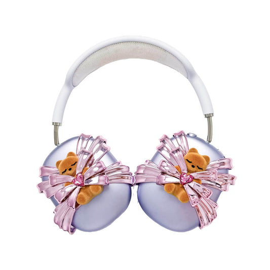 Ribbon Gummy Bear AirPods Max cover in Pink Edition, featuring a beige bear holding a pink crystal heart, surrounded by layered metallic pink ribbons.