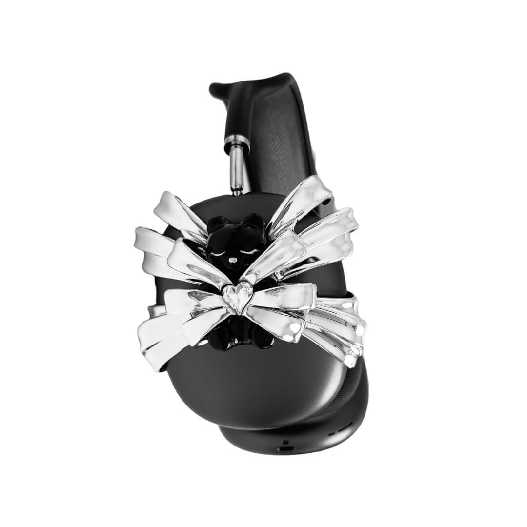 Ribbon Magic Bear AirPods Max cover featuring a glossy black bear holding a crystal heart, surrounded by layered metallic silver ribbons.