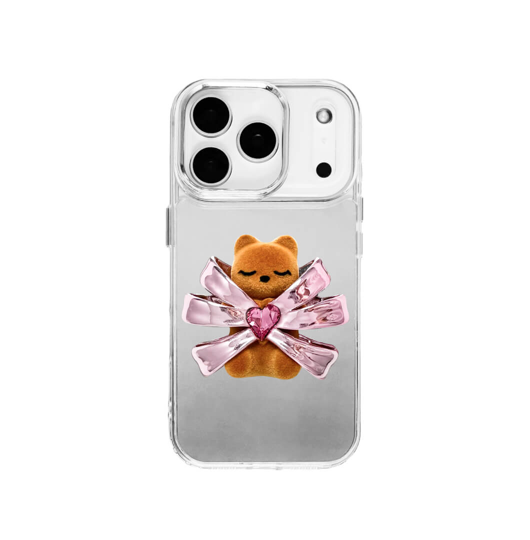 Ribbon Magic Bear iPhone Case – Pink Edition featuring a beige gummy bear holding a pink crystal heart, framed by shimmering metallic pink ribbons.
