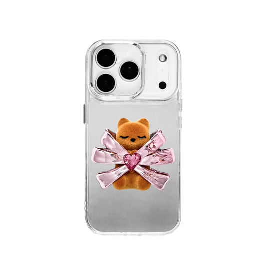 Ribbon Magic Bear iPhone Case – Pink Edition featuring a beige gummy bear holding a pink crystal heart, framed by shimmering metallic pink ribbons.