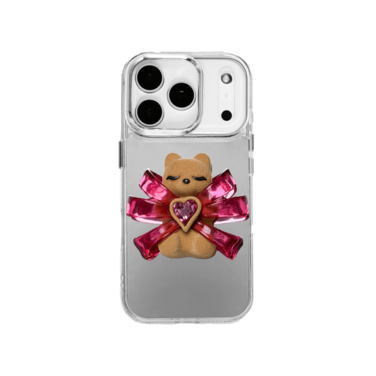 Ribbon Magic Bear iPhone Case – Pink Edition featuring a beige gummy bear holding a pink crystal heart, framed by shimmering metallic pink ribbons.
