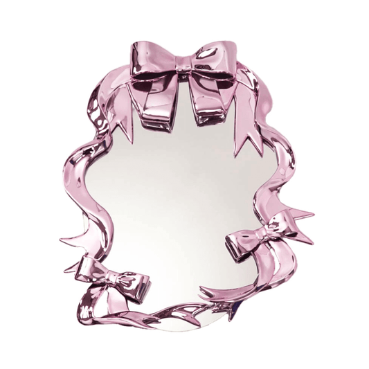 Futuristic 3D ribbon mirror in glossy pink chrome – sculptural bow-and-streamer frame surrounding an oval reflective surface with playful baroque flair