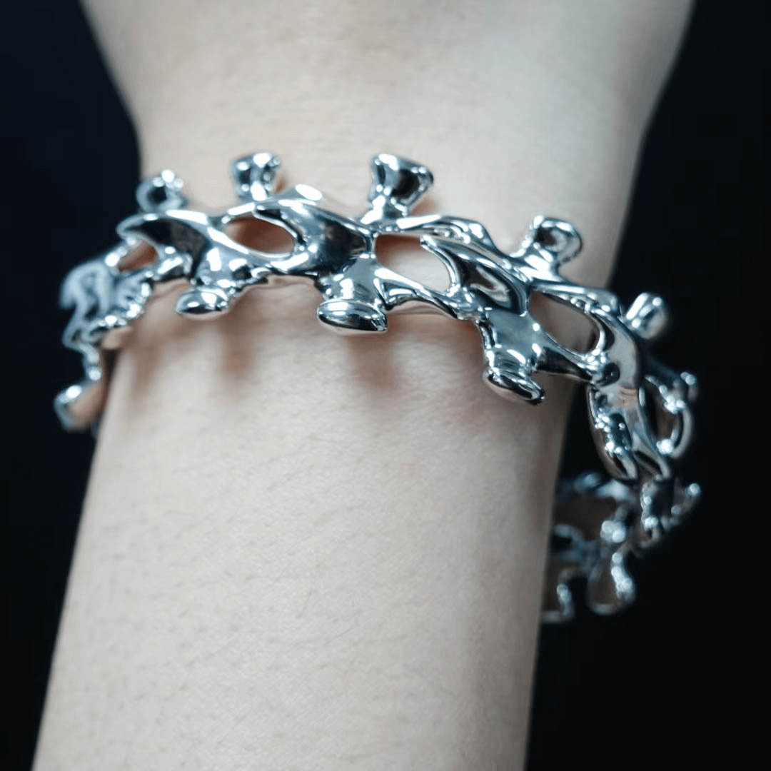 Unleash luxury elegance with the Spine Bone Bracelet. Skeletal-inspired design and oxidized finish for gothic sophistication. Perfect for unisex layering.