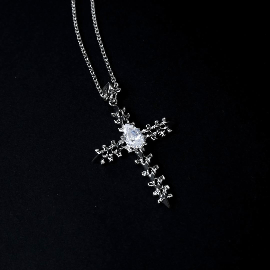Discover the SPiNE CROSS NECKLACE, a luxurious unisex necklace featuring a distinctive skeleton-inspired cross design with diamond accents. Perfect for those seeking high-end, bold, and elegant accessories.
