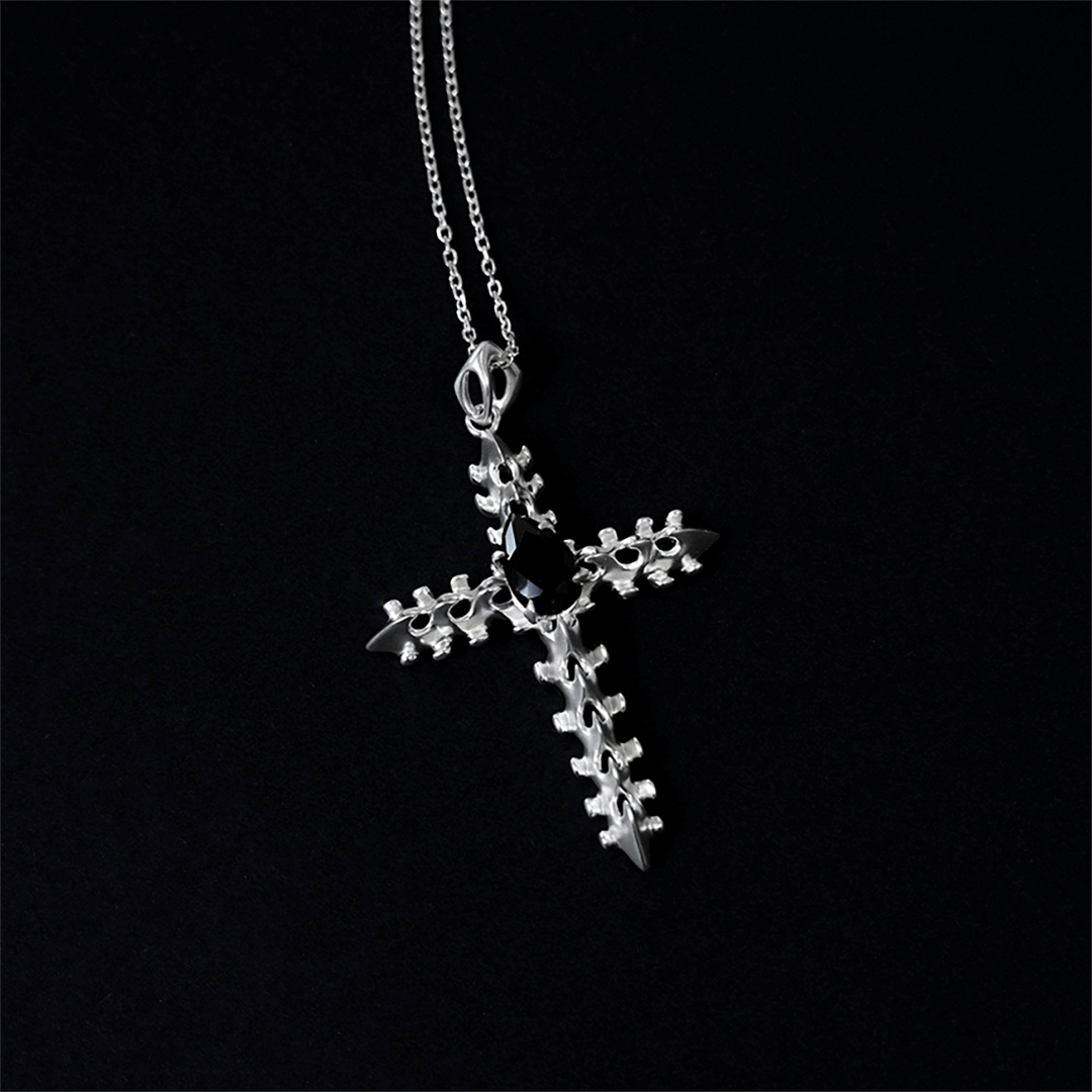 Discover the SPiNE CROSS NECKLACE, a luxurious unisex necklace featuring a distinctive skeleton-inspired cross design with diamond accents. Perfect for those seeking high-end, bold, and elegant accessories.