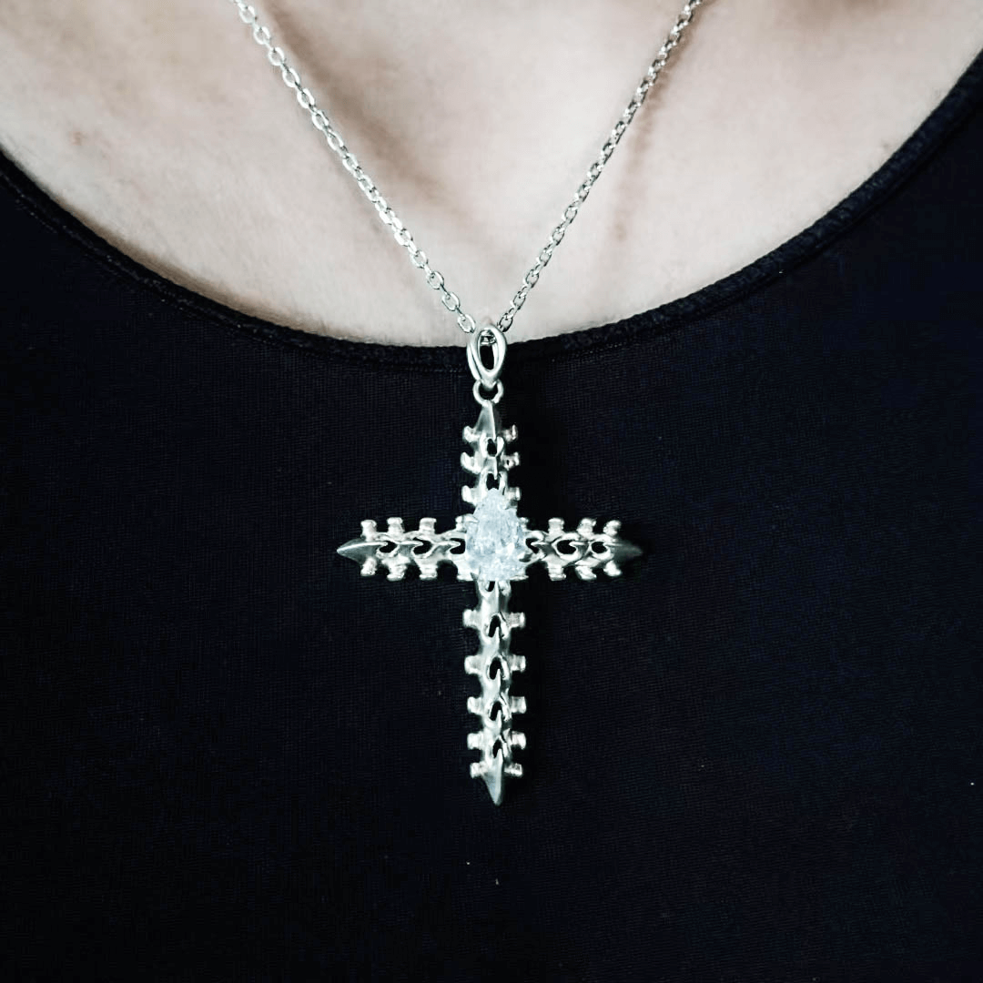 Discover the SPiNE CROSS NECKLACE, a luxurious unisex necklace featuring a distinctive skeleton-inspired cross design with diamond accents. Perfect for those seeking high-end, bold, and elegant accessories.