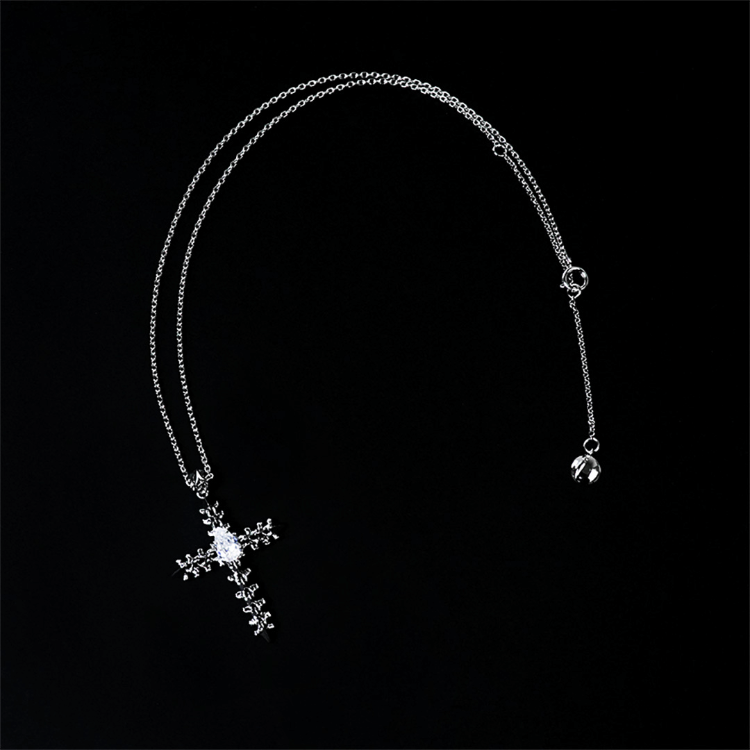 Discover the SPiNE CROSS NECKLACE, a luxurious unisex necklace featuring a distinctive skeleton-inspired cross design with diamond accents. Perfect for those seeking high-end, bold, and elegant accessories.