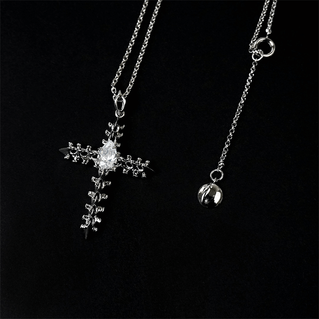 Discover the SPiNE CROSS NECKLACE, a luxurious unisex necklace featuring a distinctive skeleton-inspired cross design with diamond accents. Perfect for those seeking high-end, bold, and elegant accessories.