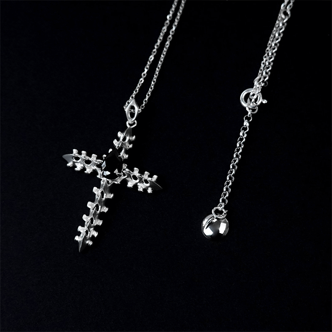 Discover the SPiNE CROSS NECKLACE, a luxurious unisex necklace featuring a distinctive skeleton-inspired cross design with diamond accents. Perfect for those seeking high-end, bold, and elegant accessories.