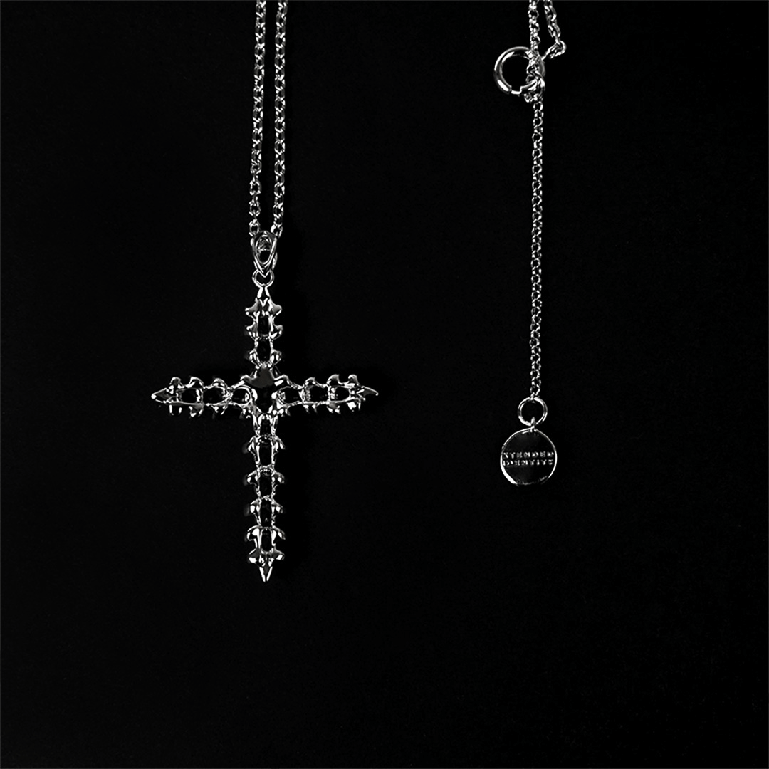 Discover the SPiNE CROSS NECKLACE, a luxurious unisex necklace featuring a distinctive skeleton-inspired cross design with diamond accents. Perfect for those seeking high-end, bold, and elegant accessories.