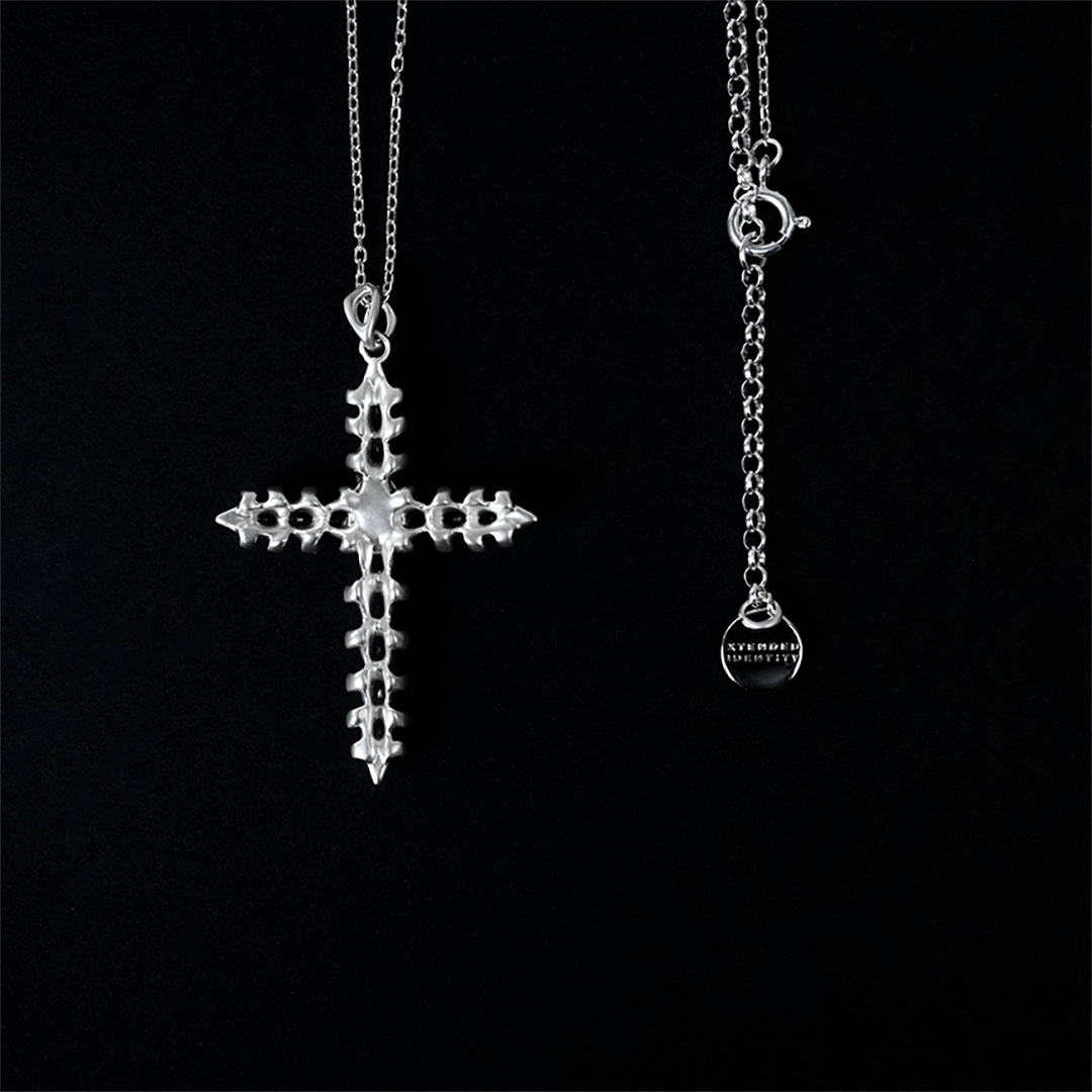 Discover the SPiNE CROSS NECKLACE, a luxurious unisex necklace featuring a distinctive skeleton-inspired cross design with diamond accents. Perfect for those seeking high-end, bold, and elegant accessories.