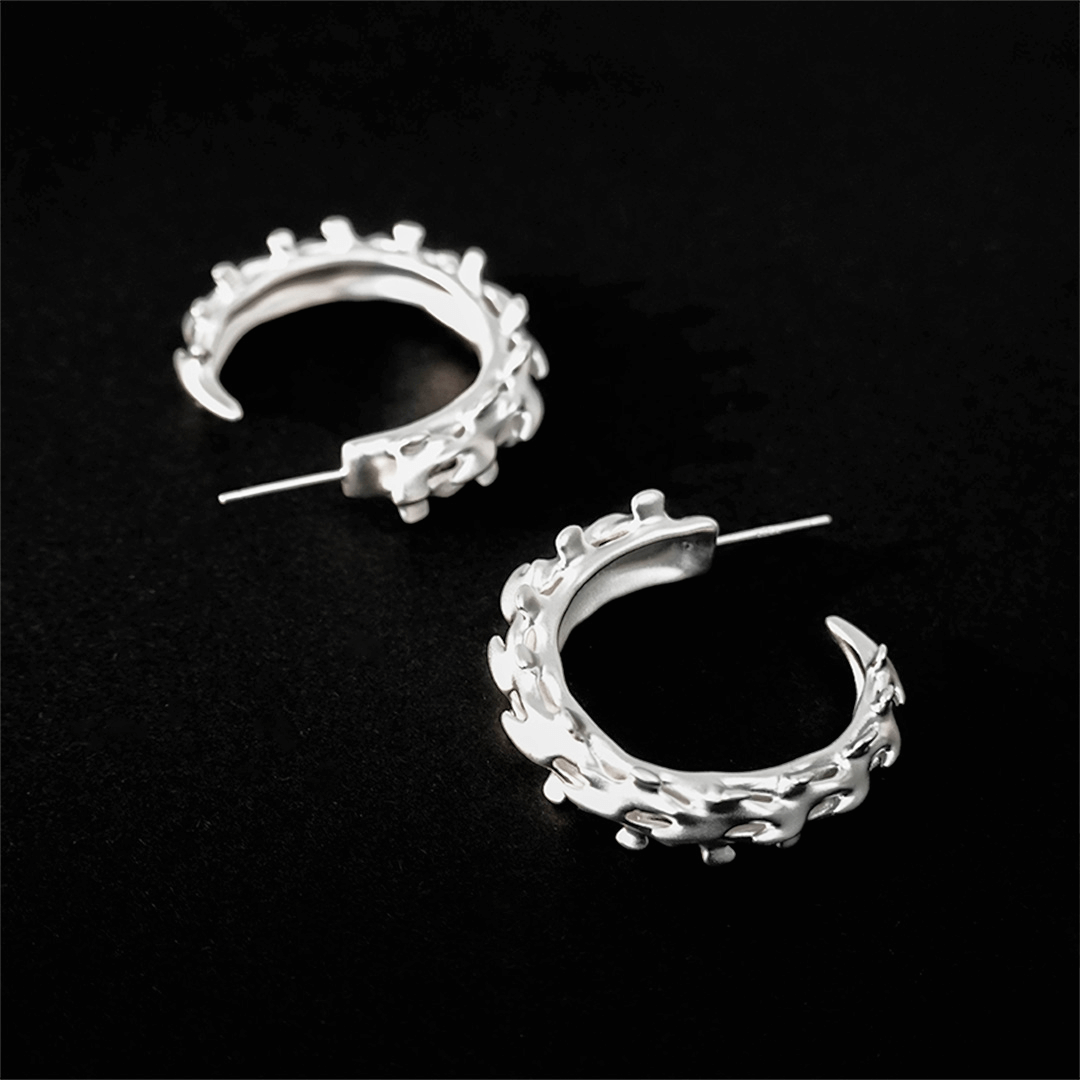 Wrap your ears in anatomical art with this luxury Spine Hoop Earrings M. Vertebra-inspired hoops for edgy stacking.