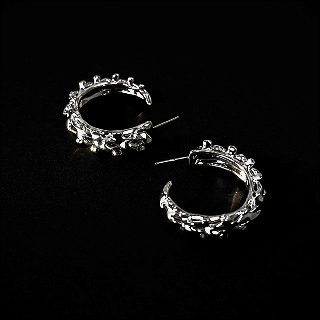 Wrap your ears in anatomical art with this luxury Spine Hoop Earrings M. Vertebra-inspired hoops for edgy stacking.