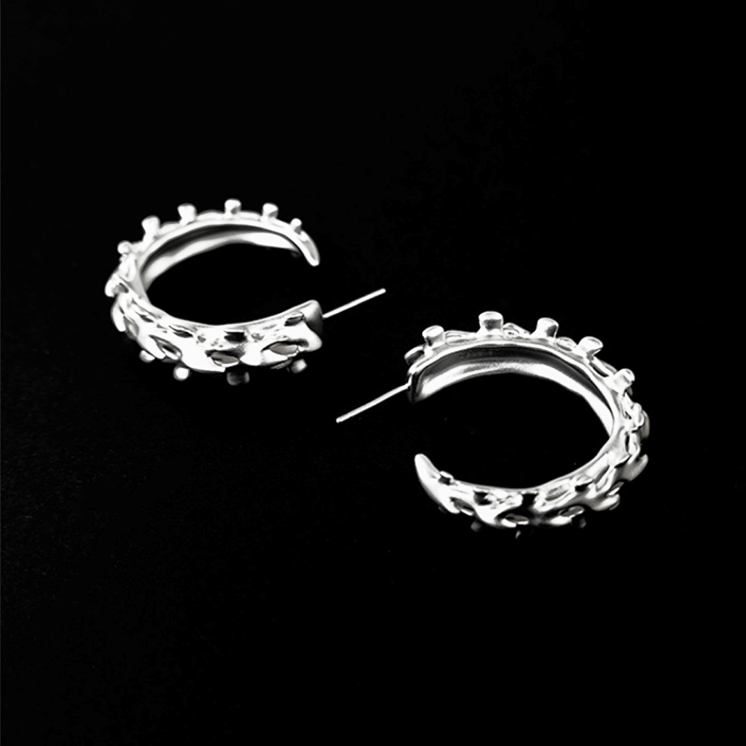 Wrap your ears in anatomical art with this luxury Spine Hoop Earrings M. Vertebra-inspired hoops for edgy stacking.