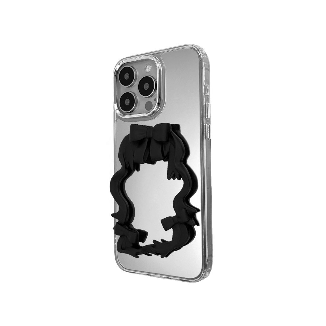 Mirror phone case with sculpted pink, silver, black and white bows and ribbon frame design, creating a romantic, soft-glam look.