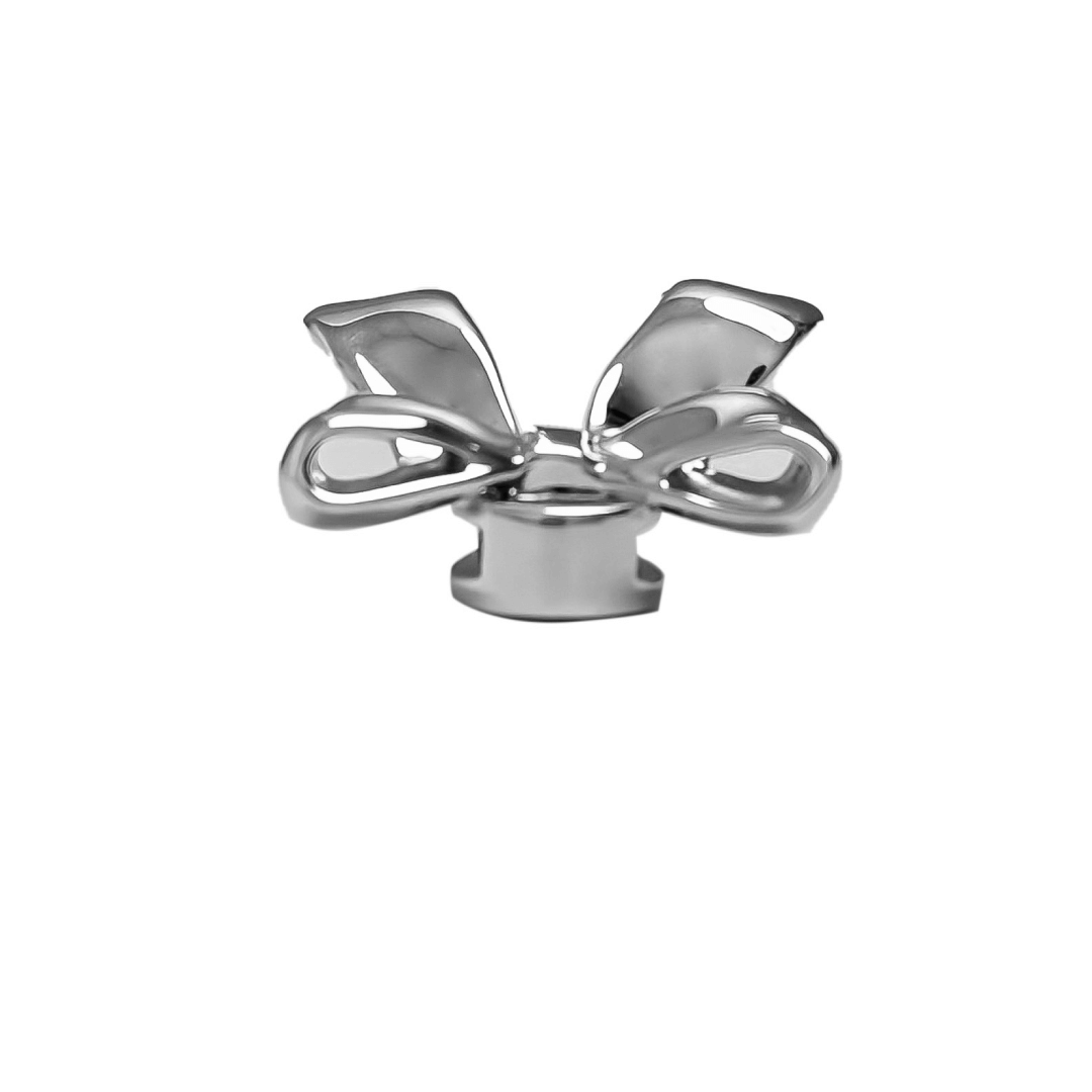 A silver metallic silken ribbon shoelace charm with flowing curves, giving a graceful and delicate accent to sneakers.