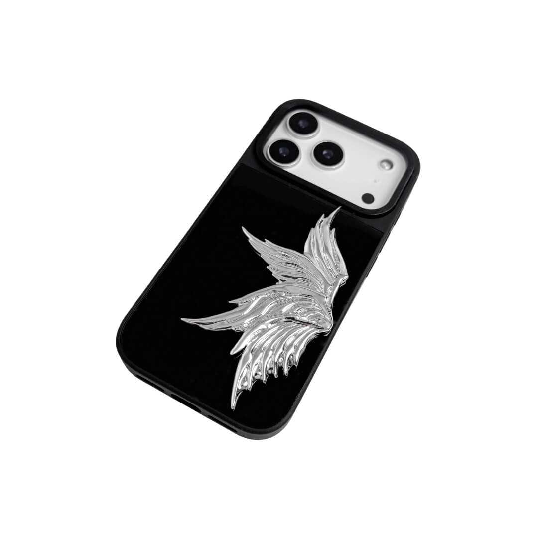 The Single Silver Angel Wing iPhone Case featuring a 3D sculpted silver metallic wing positioned on one side with an intricate feathered texture and high-shine chrome finish. Shown in three base variations: Silver, Transparent, and Black.