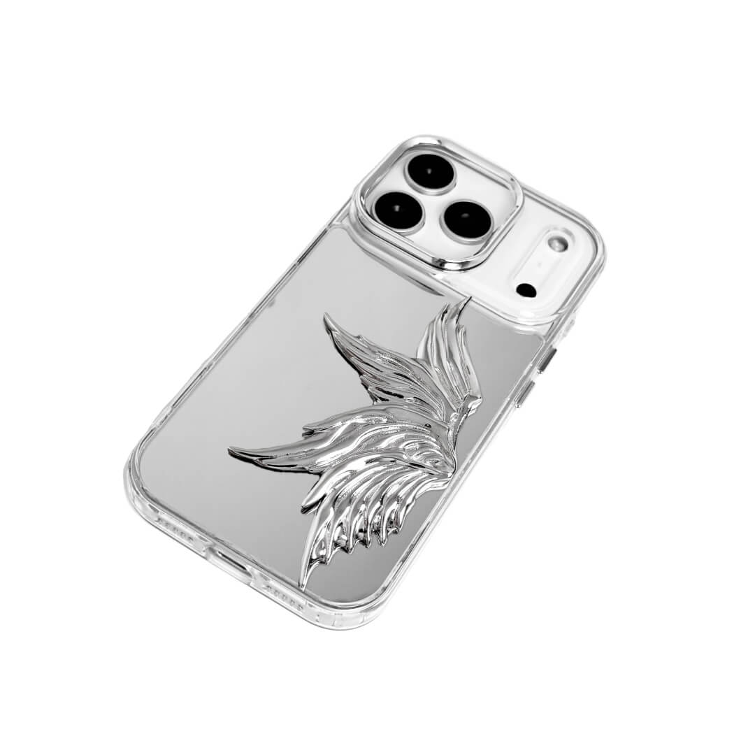 The Single Silver Angel Wing iPhone Case featuring a 3D sculpted silver metallic wing positioned on one side with an intricate feathered texture and high-shine chrome finish. Shown in three base variations: Silver, Transparent, and Black.
