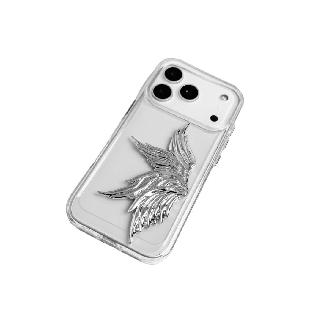 The Single Silver Angel Wing iPhone Case featuring a 3D sculpted silver metallic wing positioned on one side with an intricate feathered texture and high-shine chrome finish. Shown in three base variations: Silver, Transparent, and Black.