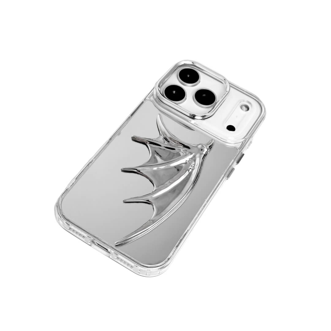 The Single Silver Demon Wing iPhone Case featuring a 3D sculpted silver metallic wing positioned on one side with a high-shine chrome finish. Shown in three base variations: Silver, Transparent, and Black.