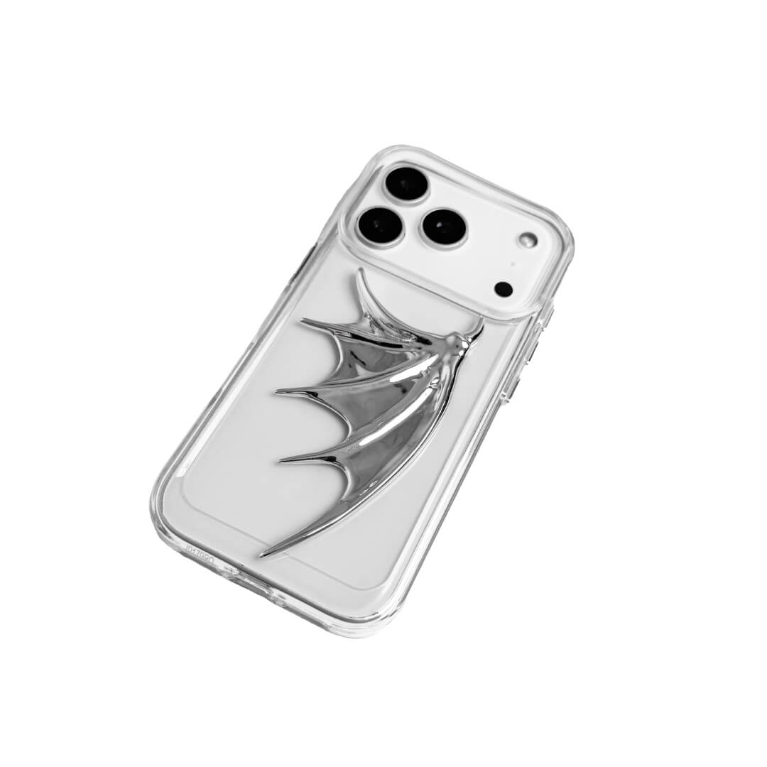 The Single Silver Demon Wing iPhone Case featuring a 3D sculpted silver metallic wing positioned on one side with a high-shine chrome finish. Shown in three base variations: Silver, Transparent, and Black.