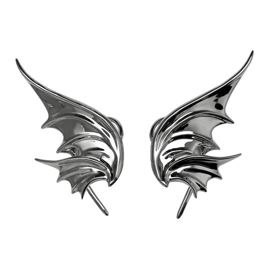 Pair of metallic bat-shaped earrings on a white background
