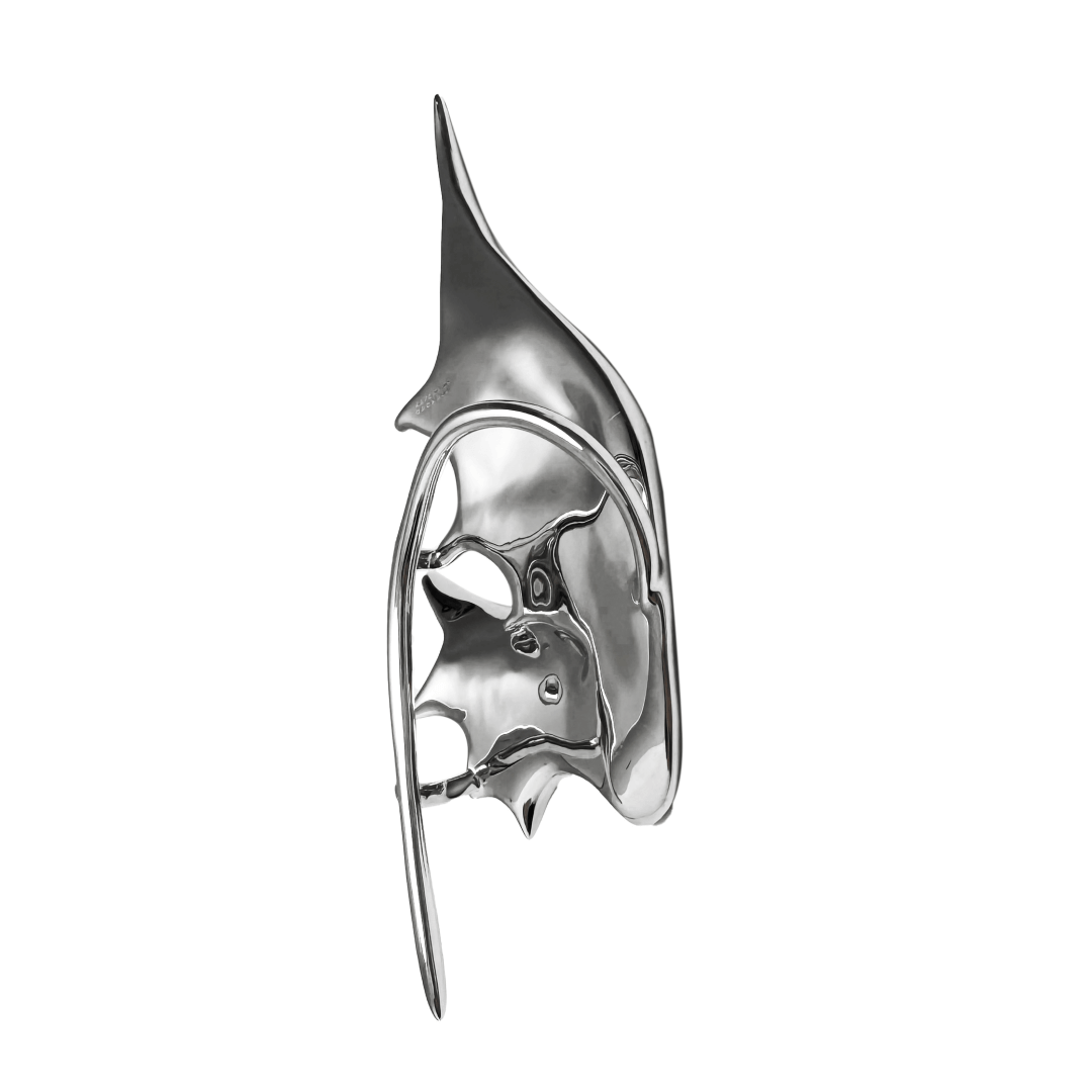 Sculptural silver ear cuffs shaped like siren-inspired wings, with a bold and futuristic design.