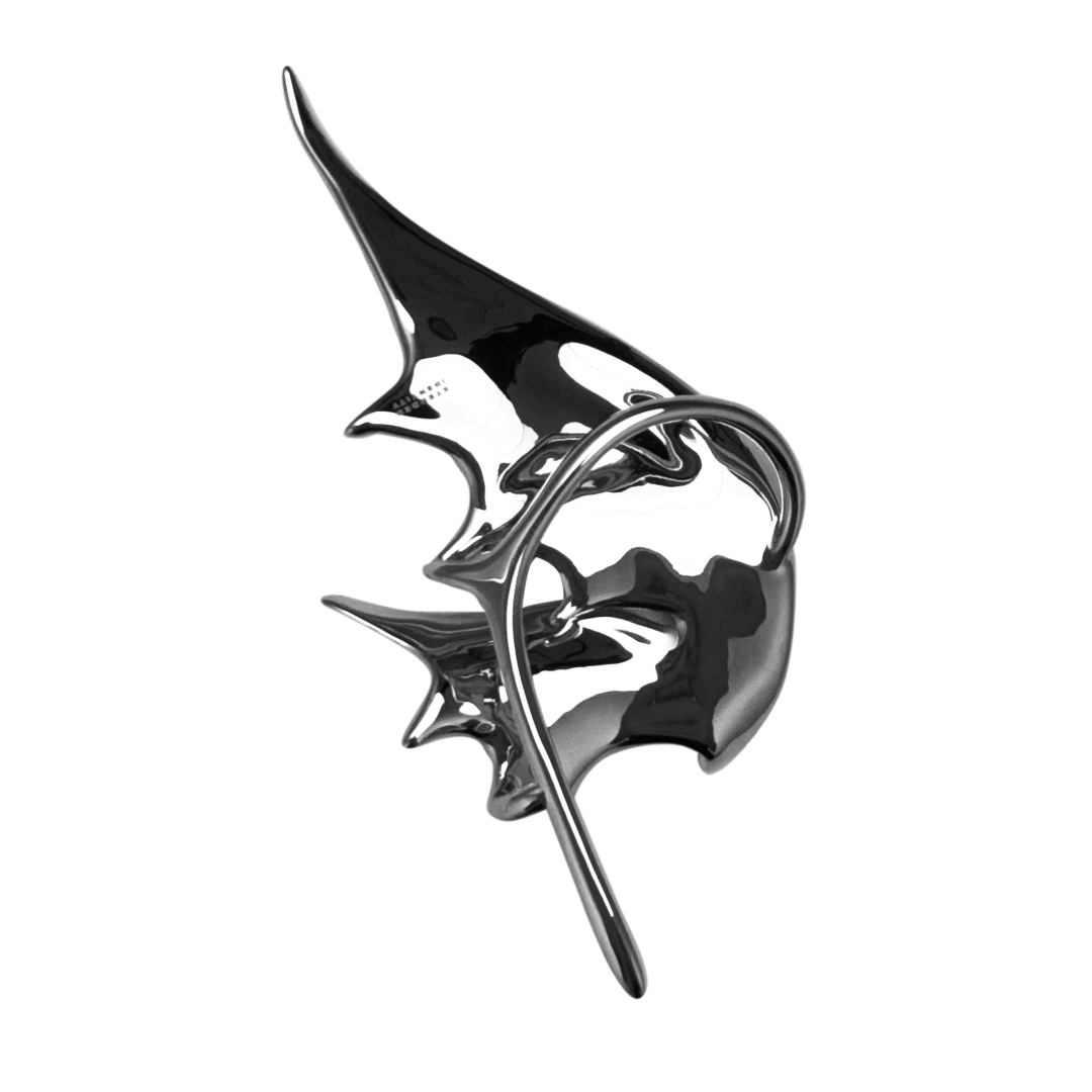 Sculptural silver ear cuffs shaped like siren-inspired wings, with a bold and futuristic design.