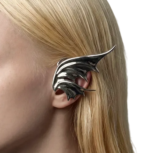 Person wearing a unique silver ear cuff against a neutral background