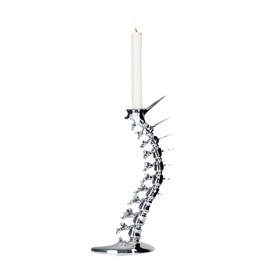 Futuristic chrome candleholder in biomorphic spinal-column form – sculptural vertebrae base studded with tiny climber figures ascending its curved backbone