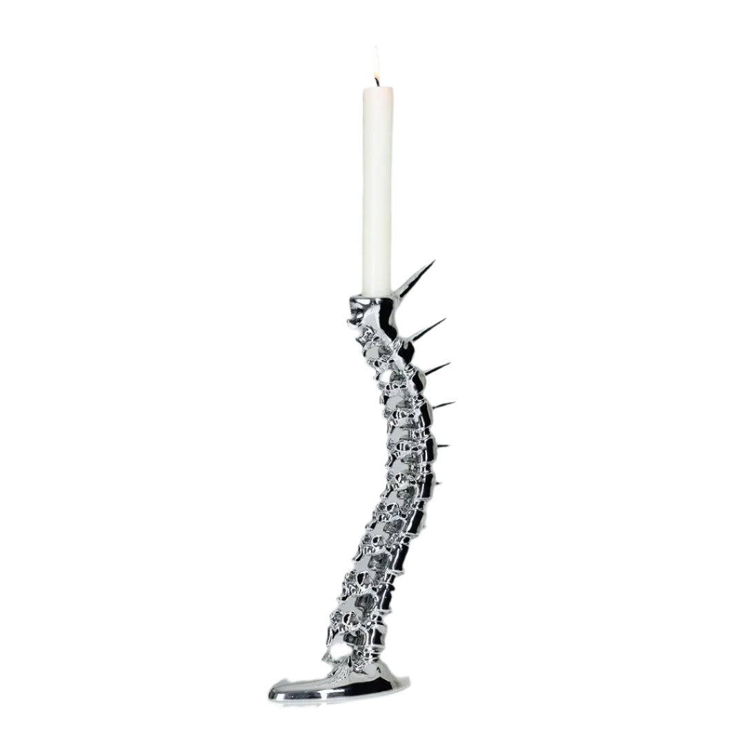 Futuristic chrome candleholder in biomorphic spinal-column form – sculptural vertebrae base studded with tiny climber figures ascending its curved backbone