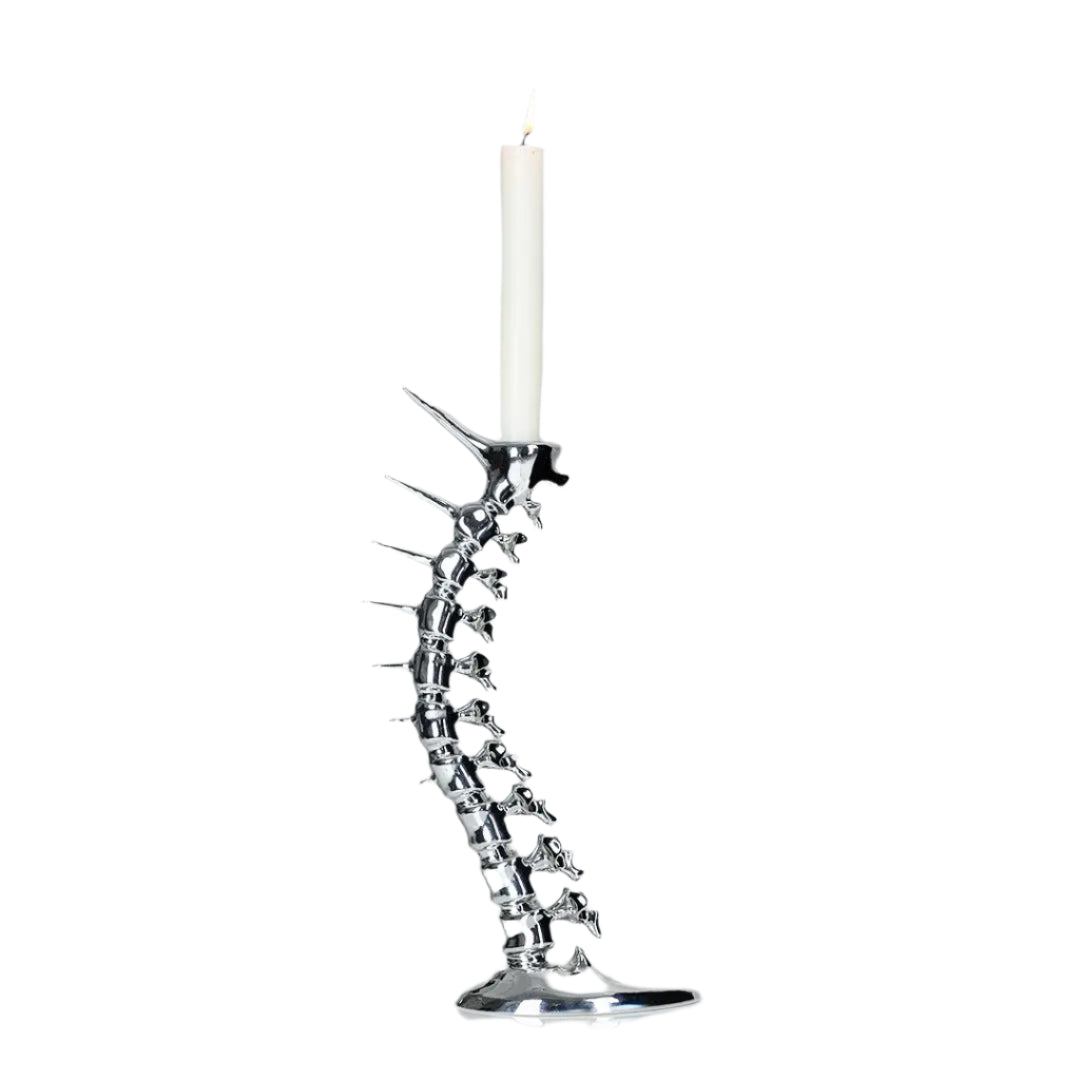 Futuristic chrome candleholder in biomorphic spinal-column form – sculptural vertebrae base studded with tiny climber figures ascending its curved backbone