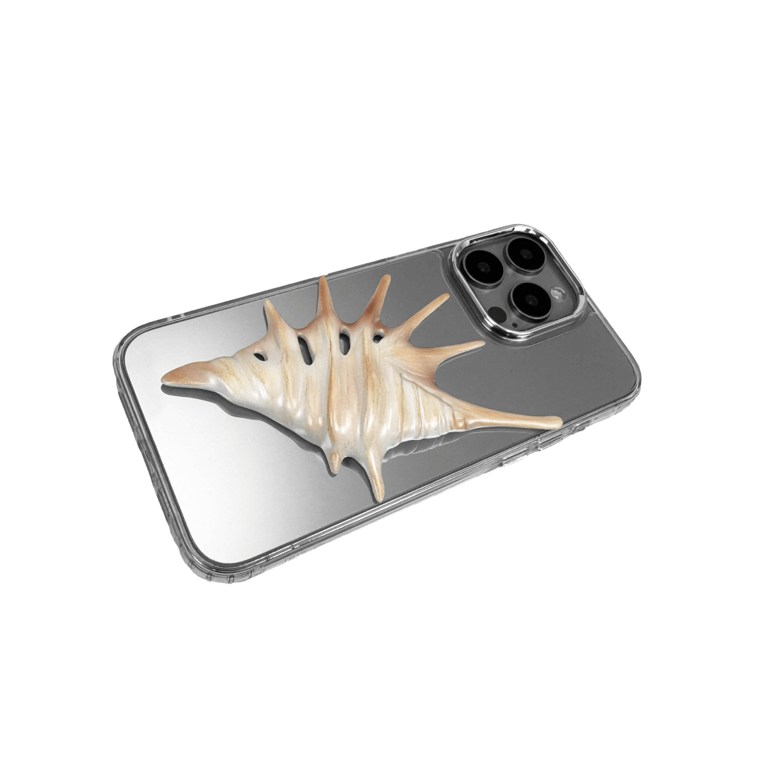 iPhone case featuring a dramatic metallic seashell sculpture with elongated, spiked ridges and pearlescent highlights.