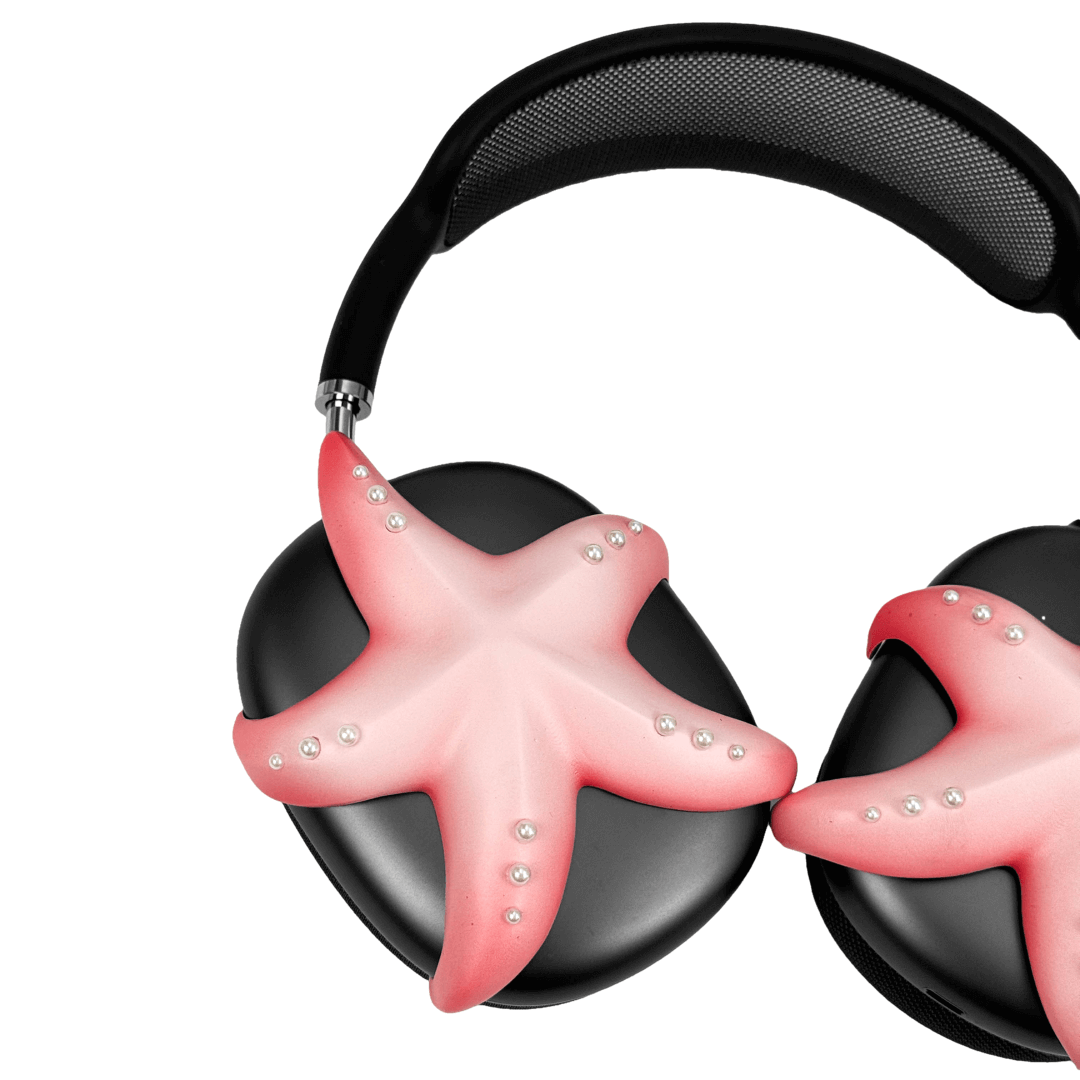 Apple over-ear headphones adorned with a metallic starfish sculpture and dot-like spheres, evoking constellations and marine elegance.
